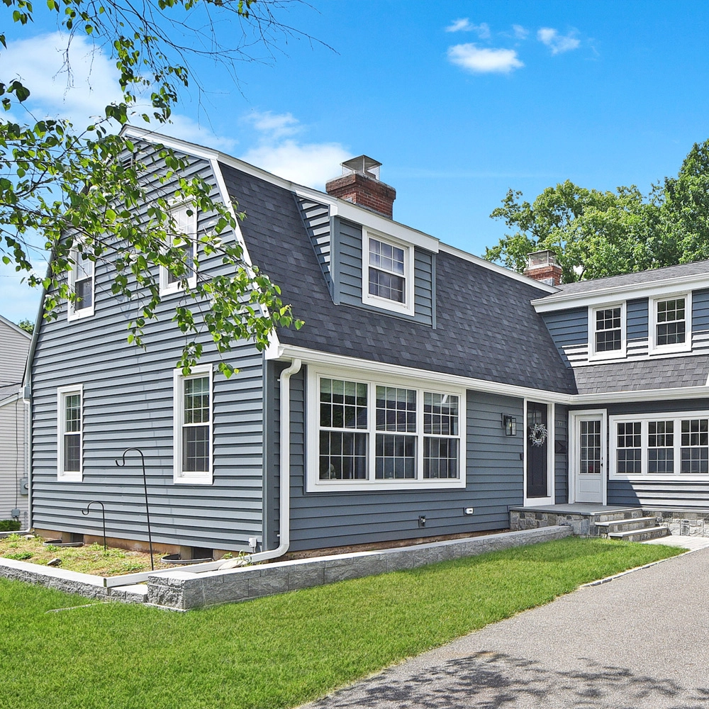 A House with light blue vinyl siding and a roof replacement